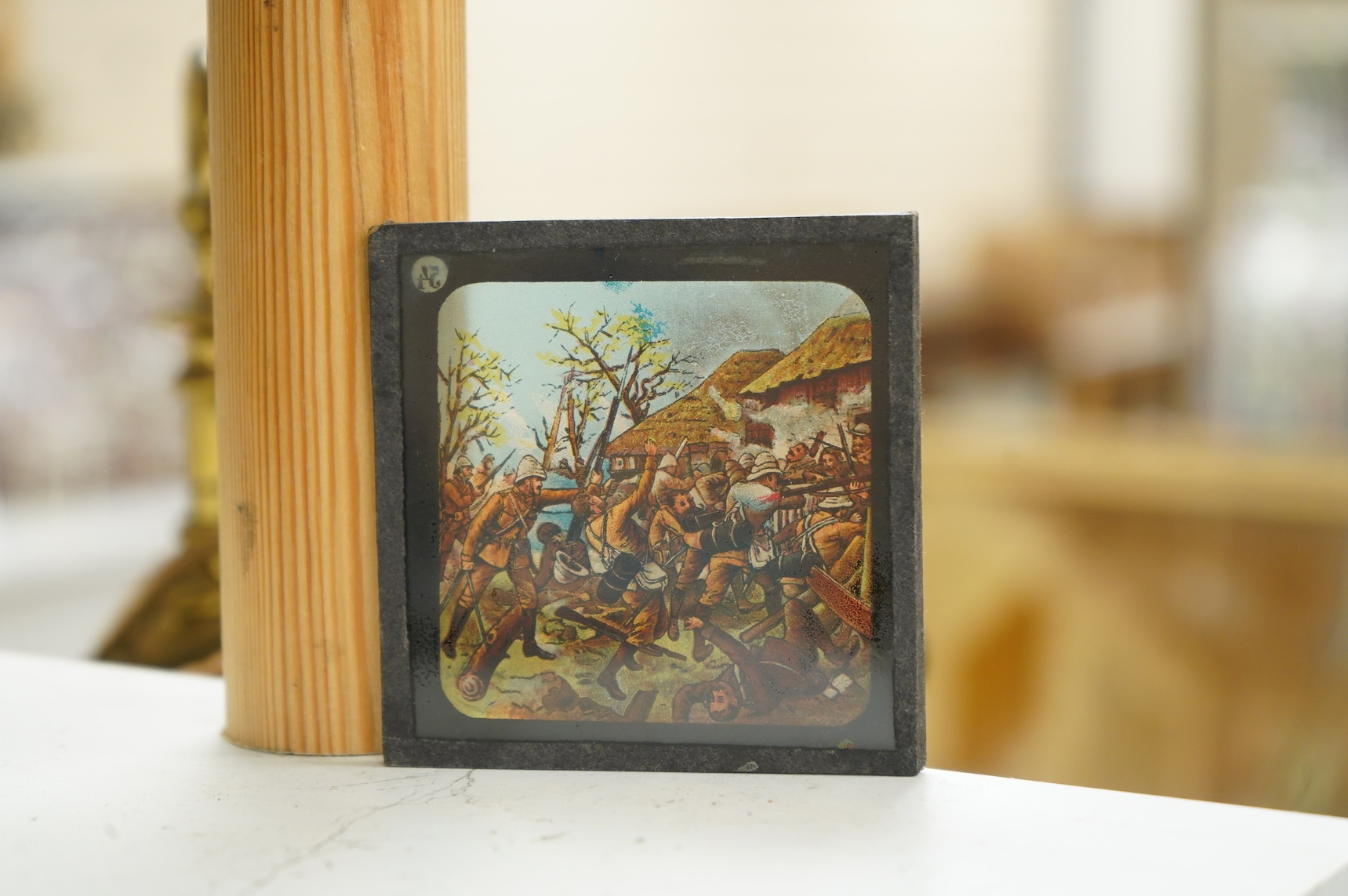 A group of sixteen Zulu War related magic lantern slides, plus some related contemporary newspaper cuttings pasted onto board referring to Rorke’s Drift